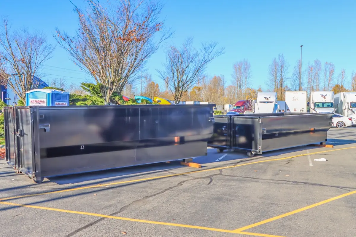 Professional dumpster rental service with roll-off container on residential driveway in Horace